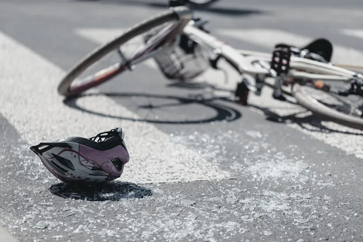 bicycle accident, broken glass, bicycle and helmet on the ground