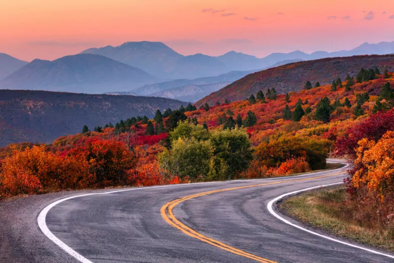 Winding mountain road and autumn landscape with vibrant fall in Colorado 