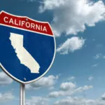 California state silhouette framed inside a blue sign with blue skies in the background