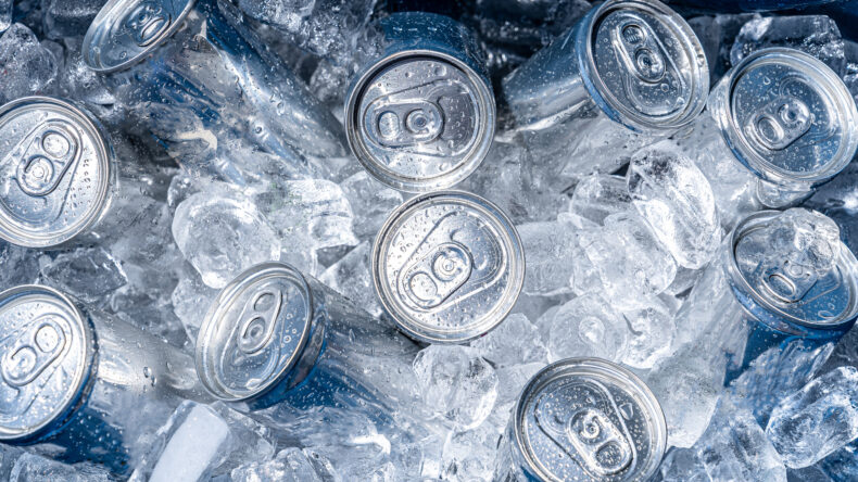 cold aluminum cans surrounded by ice inside of a cooler for super bowl party