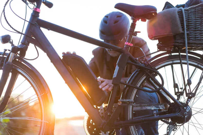 person checking electric bike battery