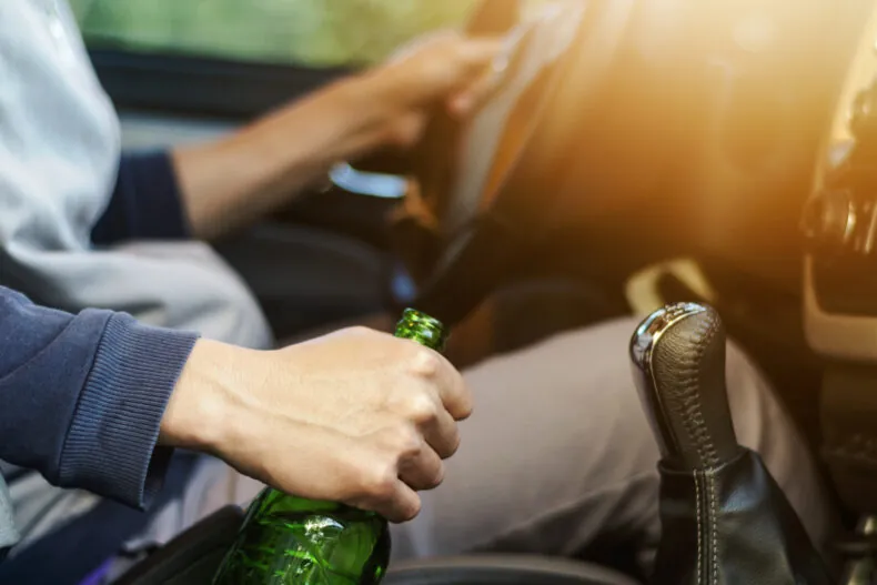 drunk driver holding a bottle