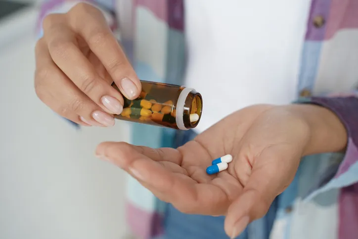 Female holding pills in palm