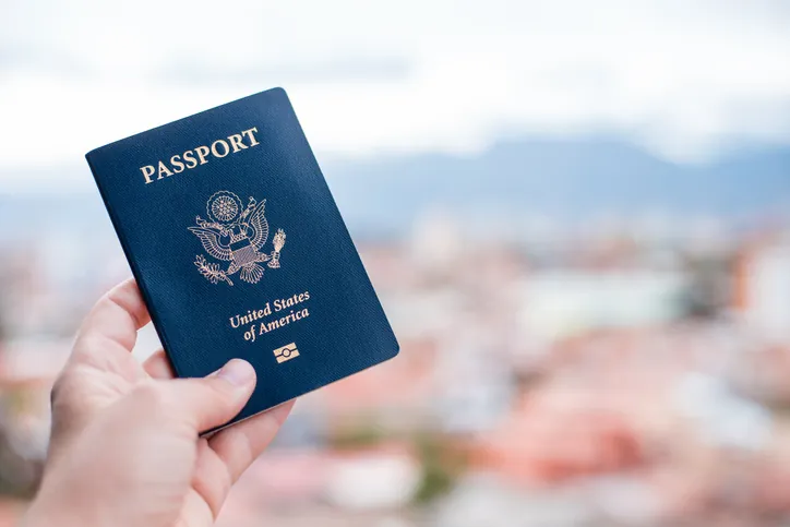 person's hand holding a U.S. passport